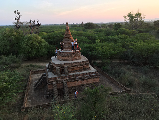 Tourists on top of a temple in Bagan, Myanmar